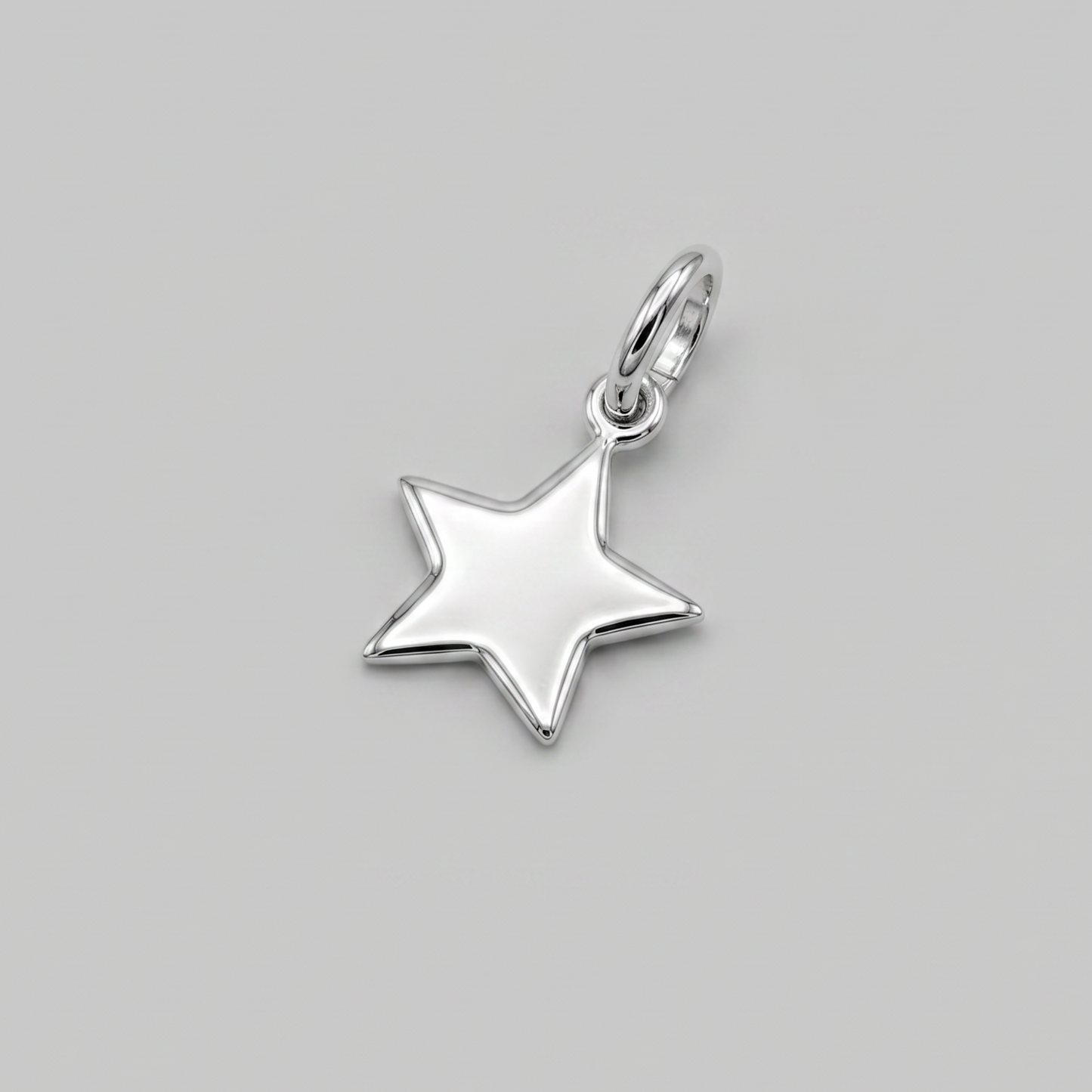 A polished silver star-shaped pendant charm with a small top loop, shown on a solid neutral gray background.