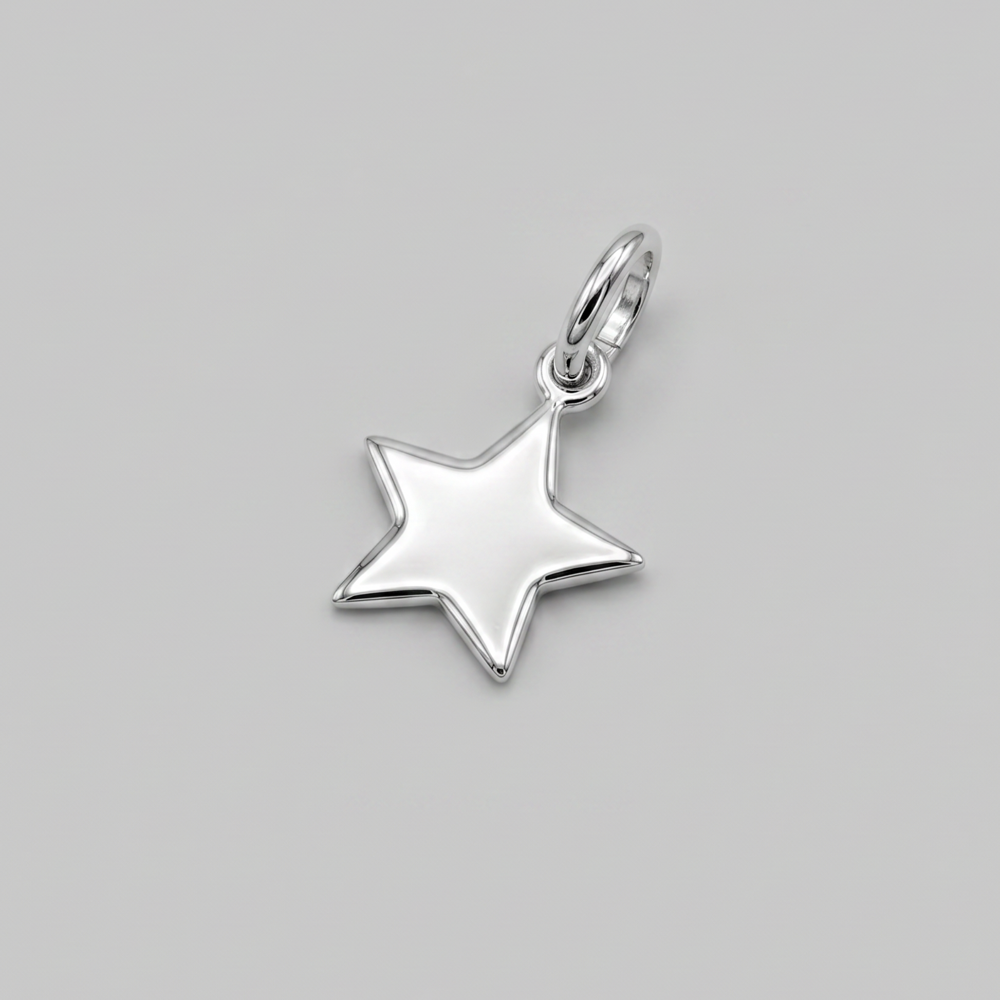 A polished silver star-shaped pendant charm with a small top loop, shown on a solid neutral gray background.