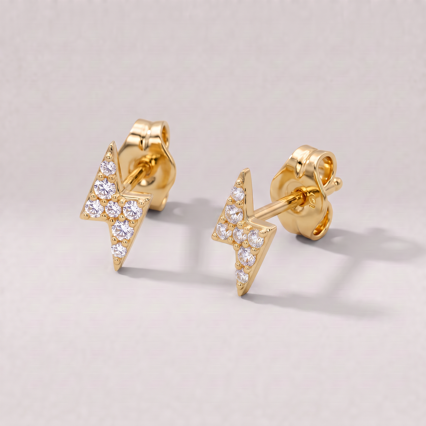 Gold plated sterling silver cubic zirconia lightning bolt stud earrings, 7.8mm, on a plain background.