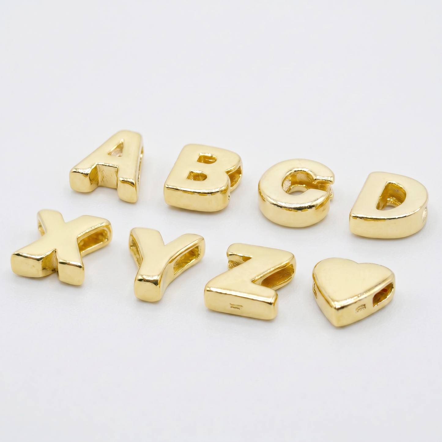 Gold plated sterling silver alphabet letter threader bead charm, A to Z, on a plain background.