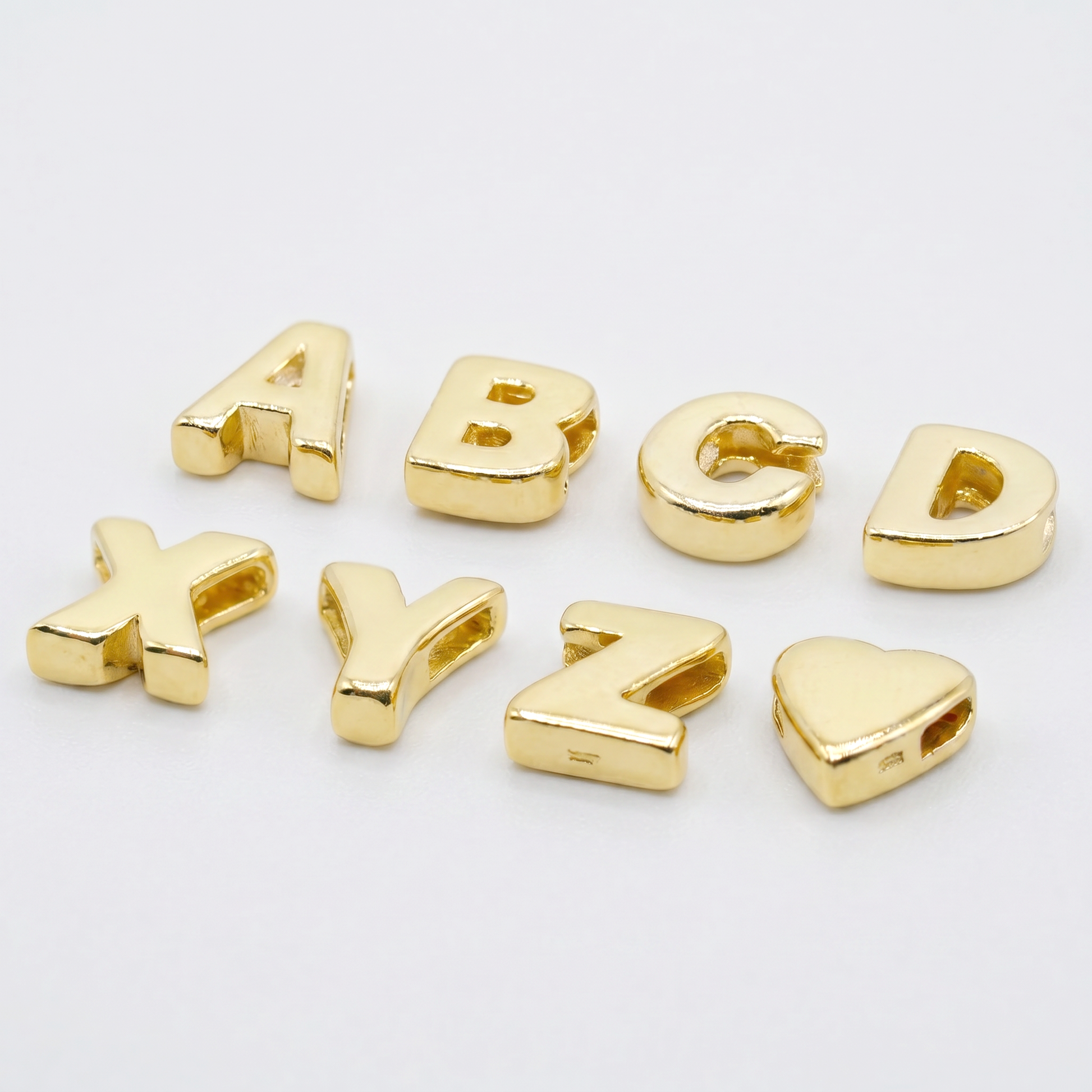 Gold plated sterling silver alphabet letter threader bead charm, A to Z, on a plain background.